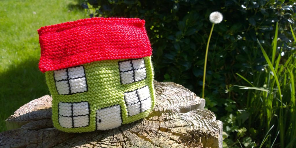 Reverse mortgage represented by a knitted house