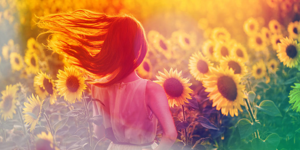A girl with sunflowers in background.